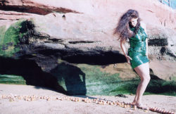 woman on beach in shiny green "little black dress"