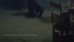very obscure dark still image of some chairs in a space, the picture is oblique and looks candid.